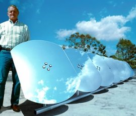 Photo of a man standing next to a row of silver, metallic panels anchored to the ground with a horizontal bar.